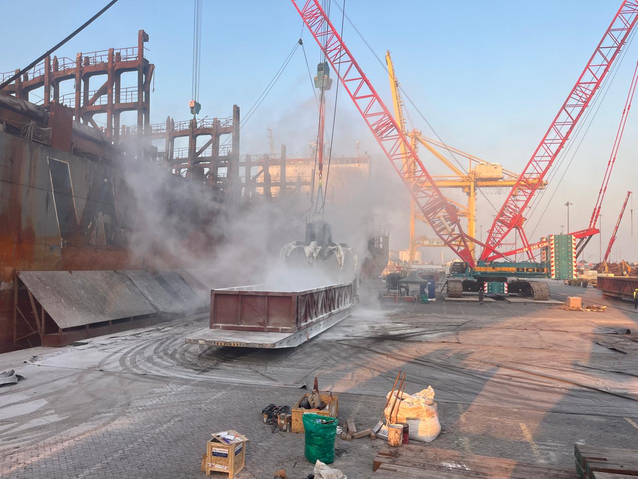 Heavy salvage cranes and equipment working alongside a casualty vessel