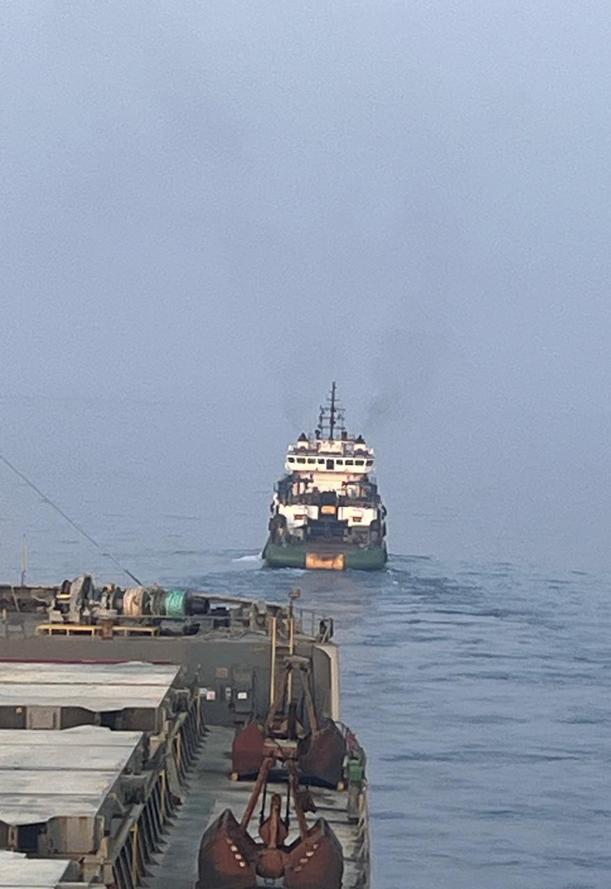 Tug vessel towing a barge in open water